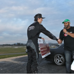 Yoshi presents Nigel with the third place getters cheque